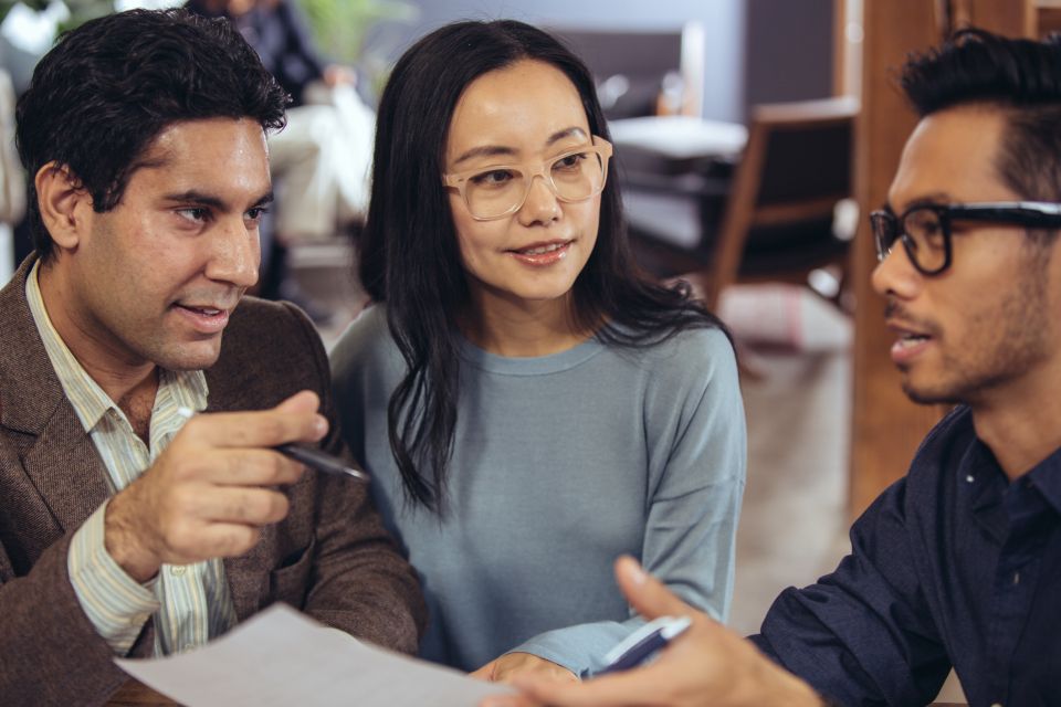 an advisor is meeting with a couple and providing banking advice