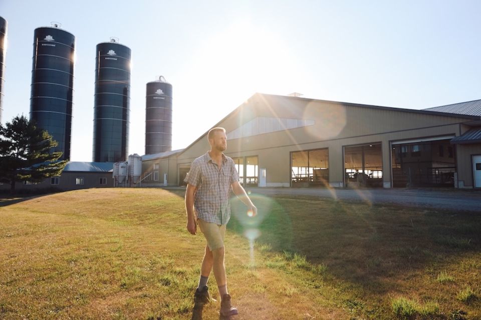 Man walks in front of a farm building in Canada