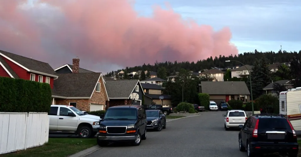 Wildfire in Canada. Smoke from a wildfire rise in sky above city