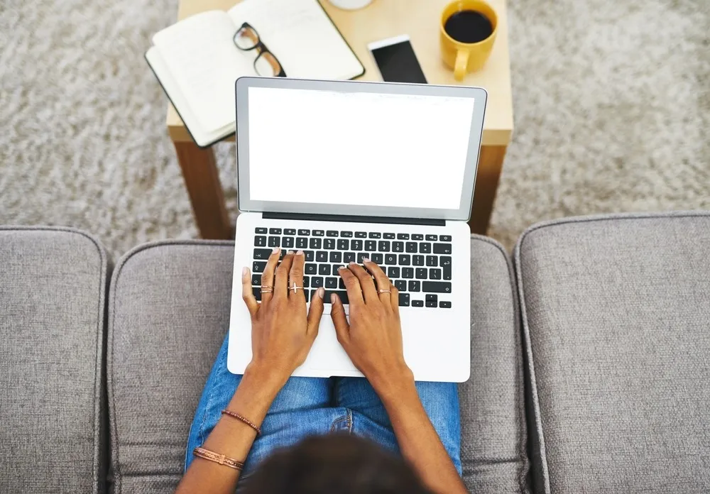 A woman using a computer to browse the internet, while avoiding fake websites.