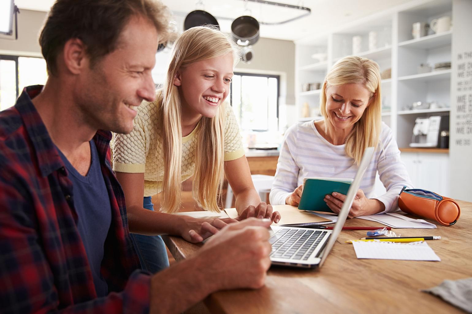 Jeune fille qui aide ses parents à apprivoiser une nouvelle technologie.