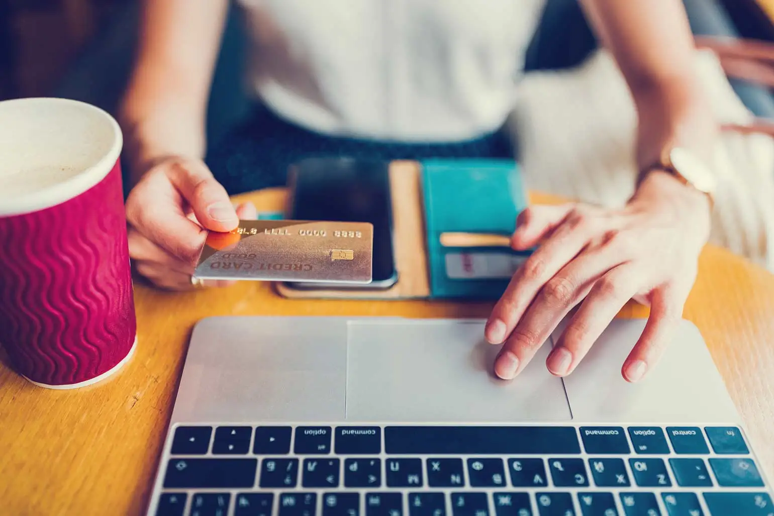 Female hands paying credit card bill on laptop