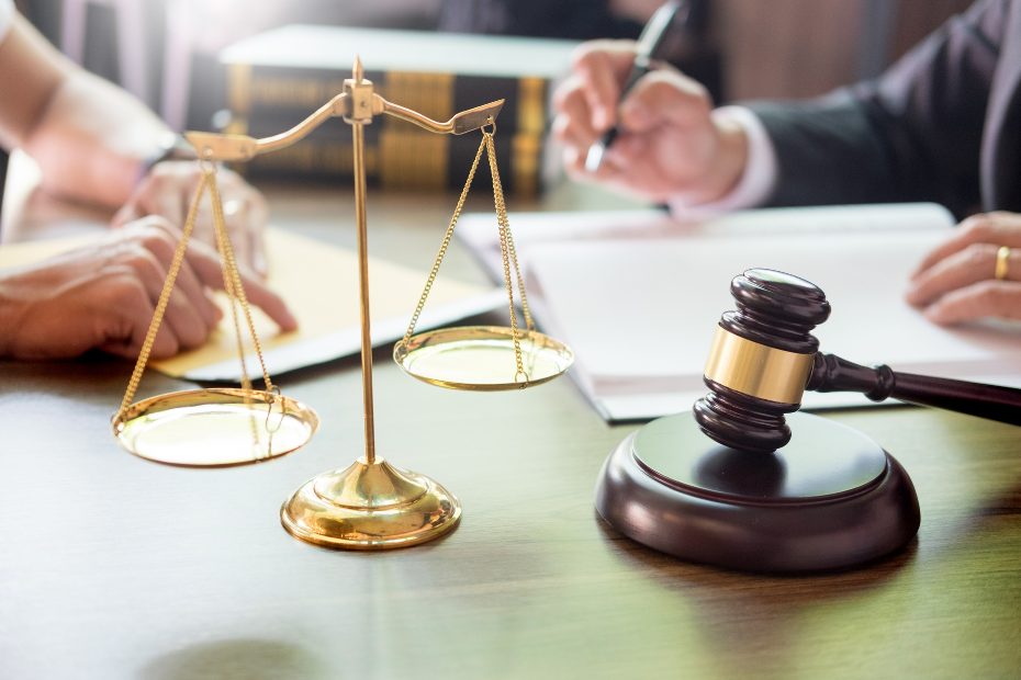 A desk with a gavel and legal paperwork