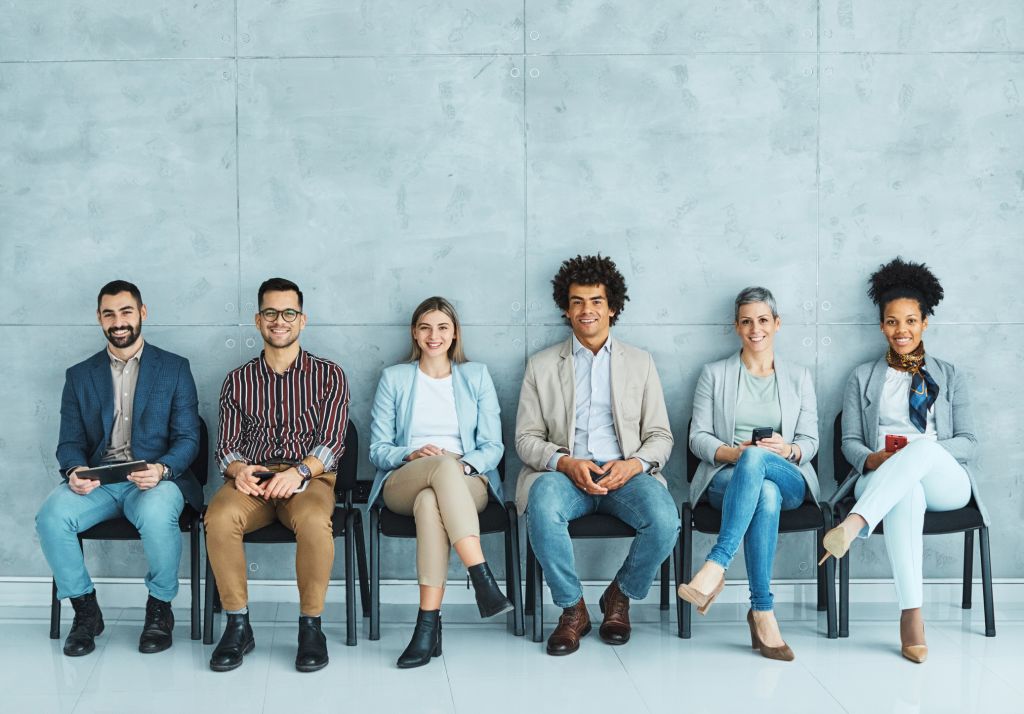 A diverse lineup of people, waiting for their interview.