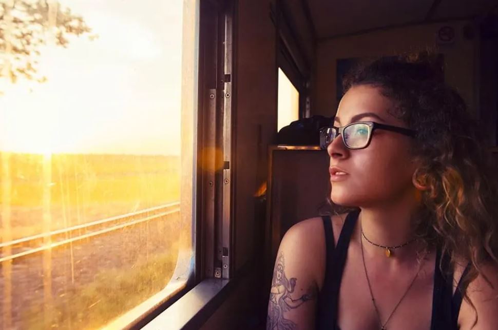 Image d’une jeune femme voyageant en train