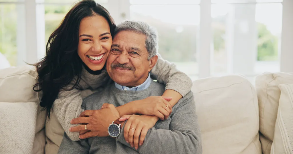 Father with daughter smiling.