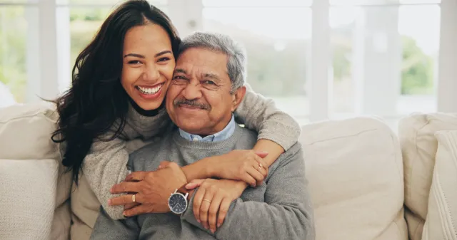 Father with daughter smiling.